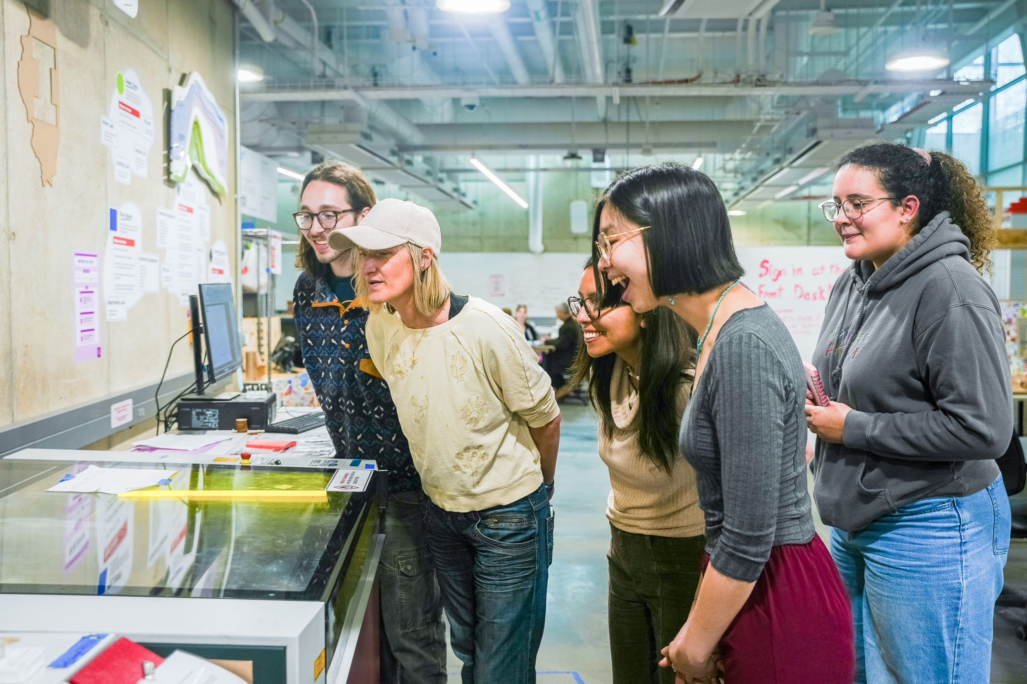 Min Ya and her TAs react to seeing the laser printer in action