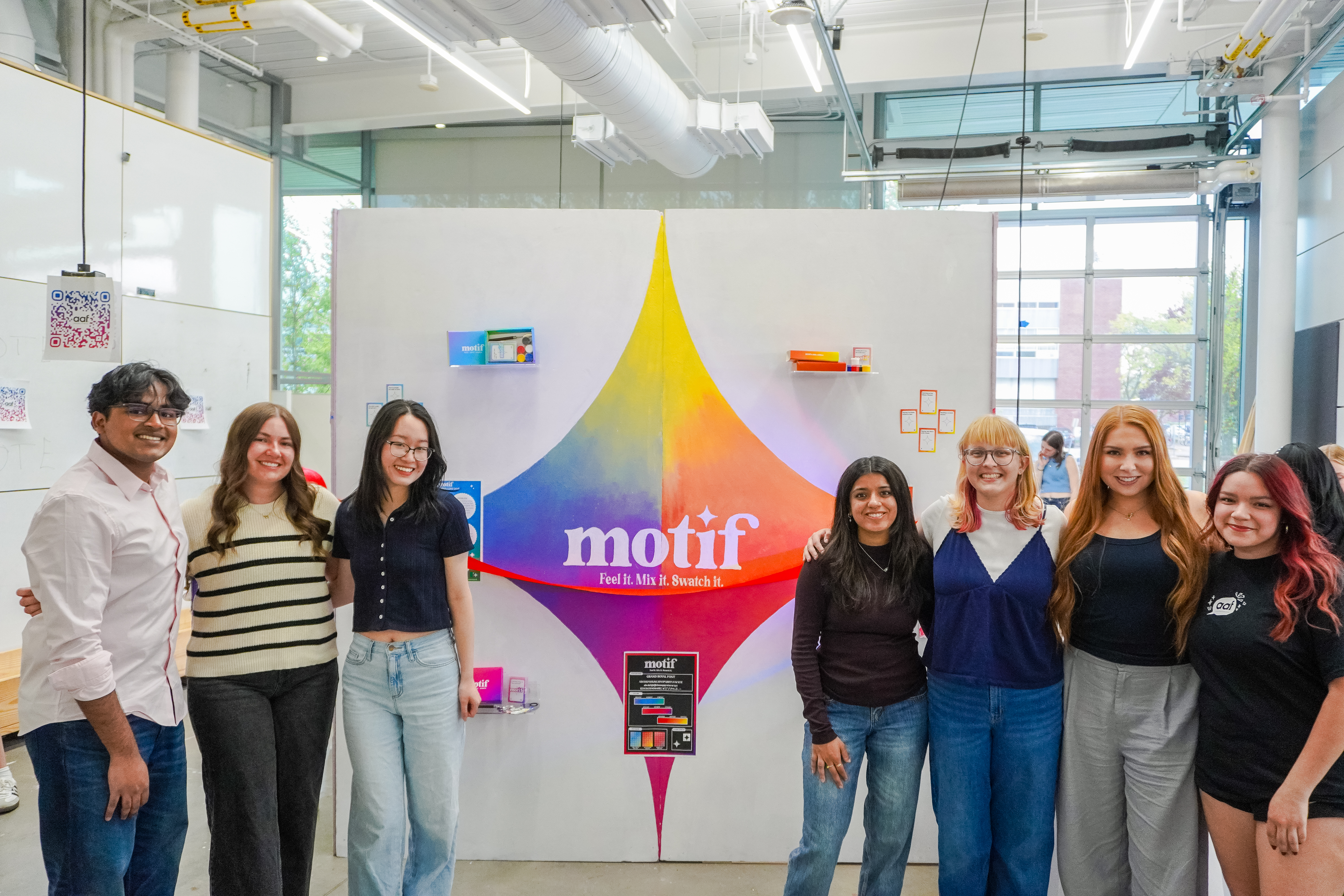 AAF students pose in front of 'Motif' signage, a part of their Build-It experience